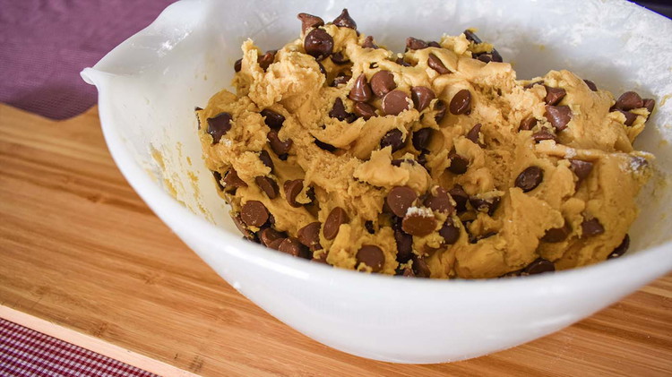 Image of Add dry ingredients; flour, pudding mix, and baking soda. Then fold in chocolate chips.