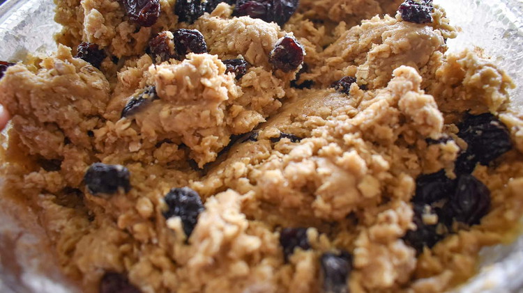 Image of In another bowl, mix dry ingredients (besides raisins). Then gradually add the sugar and butter mixture and combine well. Fold in raisins.