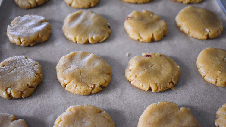 Image of Flatten dough balls to 1/2 inch thickness with a floured spoon.