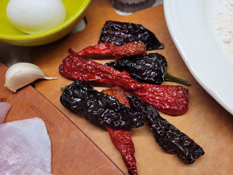 Image of Rehydrate 6 dried chiles. Place the chiles in a sauce pan with enough water to fully cover and bring to a low boil. Once the water is rolling remove the pan from the heat and set aside. Let the chiles...