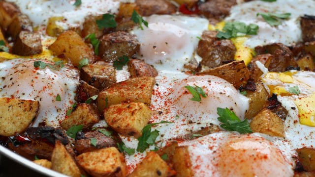 Image of Potato, Caramelized Onion, & Roasted Red Pepper Hash with Baked eggs & Olive Oil 