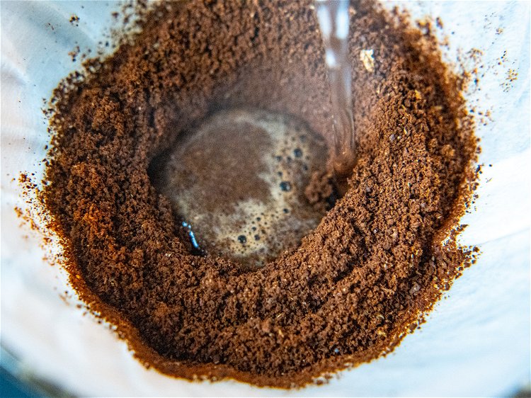 Image of Add in ground coffee and put a divot into the...
