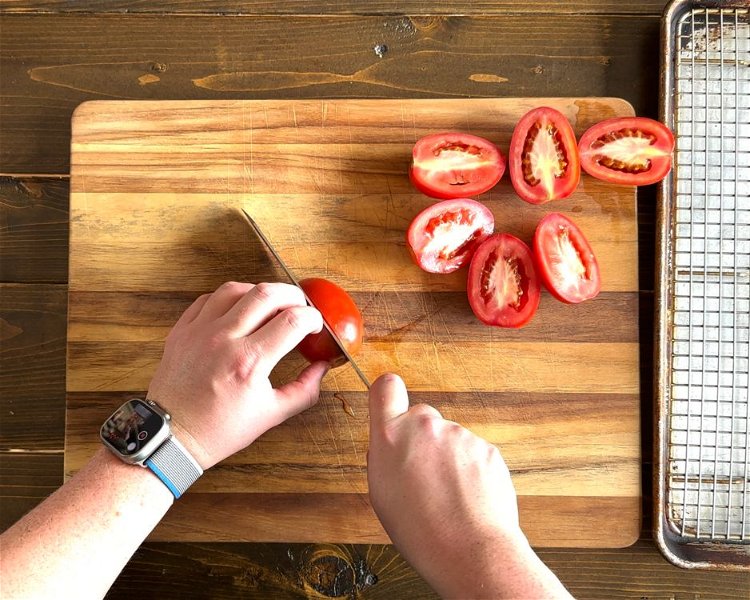 Image of Cut the tomatoes in half length wise and place tomatoes...