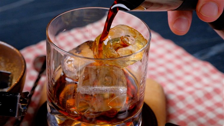 Image of Die Eiswürfel werden in ein Glas gegeben. Der Wodka und...