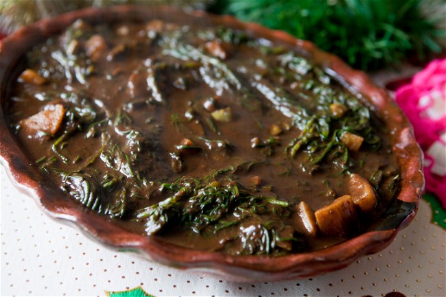 Image of Romeritos (a herbaceous vegetable stew typically served with shrimp and mole sauce)