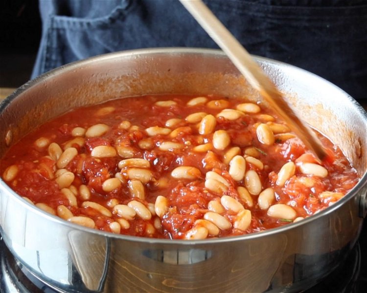 Image of Stir in tomatoes and beans. Bring the mixture to a...