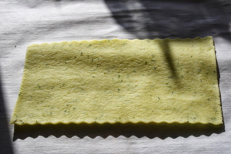 Image of In a large bowl or the bowl of a food processor, mix together the flour. Make a well in the center of the flour if not using a food processor, and add the eggs, olive oil, and dill if using.