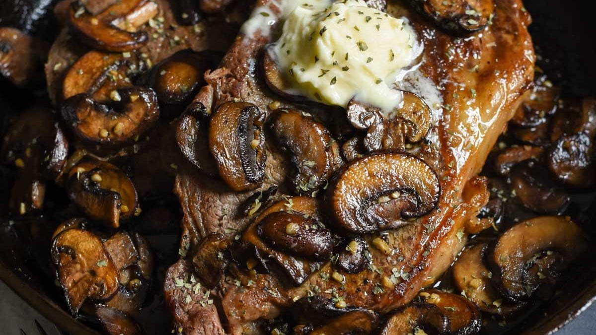 Image of Ribeye Steaks with Blue Cheese Butter and Mushrooms