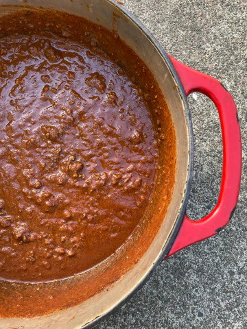 Image of Pre-heat a large, heavy bottom pan or enameled Dutch oven (with lid) over medium heat, then add the butter, ground elk, diced onion, garlic and salt.