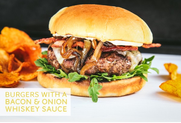 Garnished burger paired with potato chips.