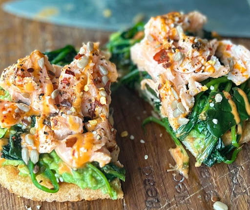 Image of Cajun tartine with New Zealand King Salmon, smashed avocado, spinach, mixed seeds & chilli