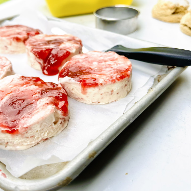 Image of Freeze until firm and use a 3” round cutter and small offset spatula to cut circles of jam topped ice cream for your Strawberry Shortcake Sandwiches. Place cut circles on parchment lined sheet tray and return to freezer until ready...