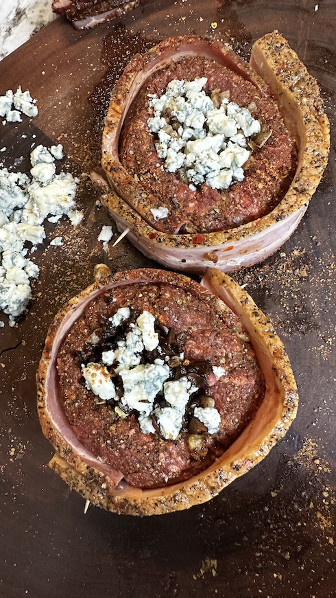 Image of Sauté your onions and mushrooms. Once they’re done, make two half-pound patties with your ground elk. Next, take an aluminum can (beer can or soda can) and place it in the middle of each patty. Press the can into the...