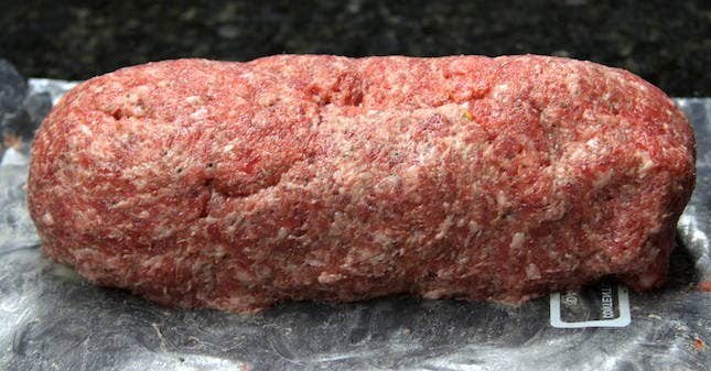 Image of Carefully roll the sausage and transfer it to plastic wrap.