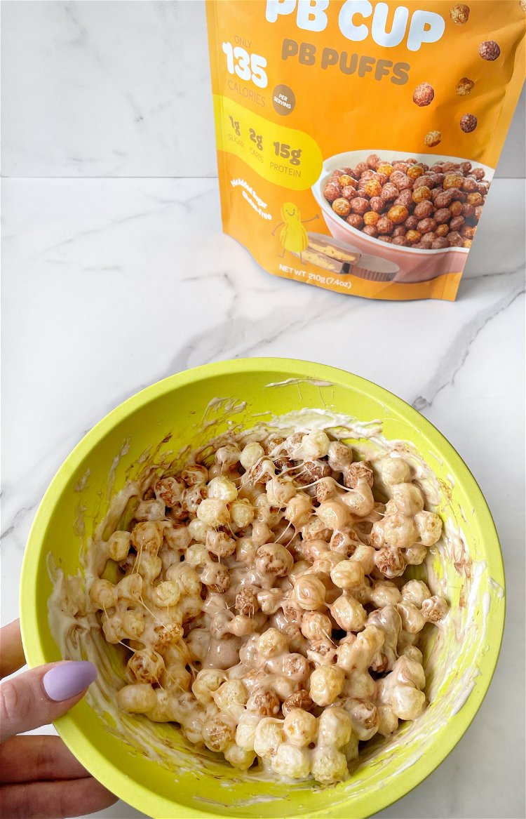Image of Add the cereal to the melted marshmallow mixture and stir...