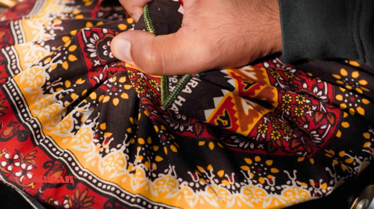 Image of Wrap the lid with a  cloth to help with steam cooking and place the lid on the pan.