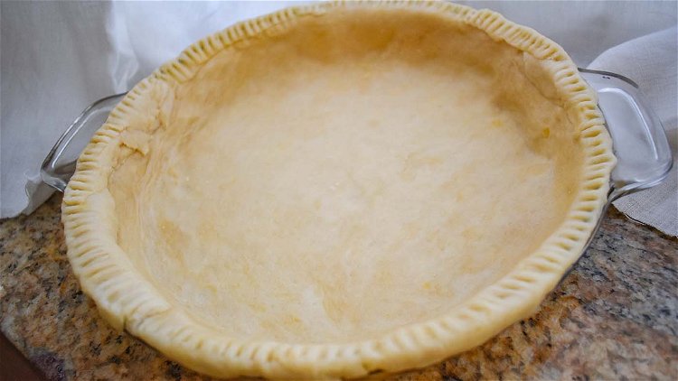 Image of Line a 9-inch pie pan with pastry and bake in...
