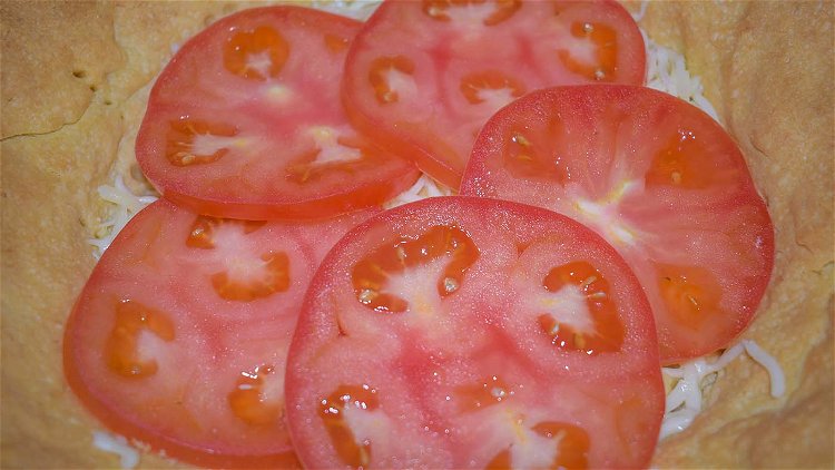 Image of Layer half of the tomatoes over the cheese. Season to...