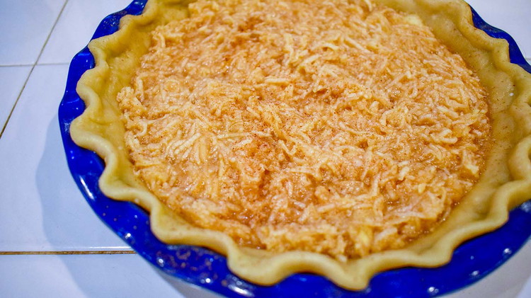 Image of Pour apple mixture into an unbaked pie shell.