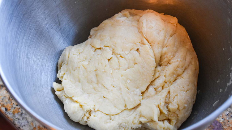 Image of Add egg, vinegar, water, and mix. Squeeze with hands to make sure all is combined.