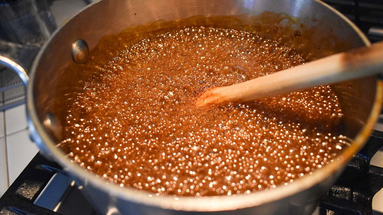 Image of Turn off heat and stir in molasses then quickly whisk in the beaten egg.