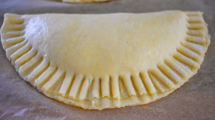 Image of Seal pies with finger or fork. Make sure edges are sealed properly. Remove excess filling if needed.