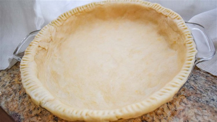 Image of Preheat the oven to 350°. Line a 9-inch pie pan...