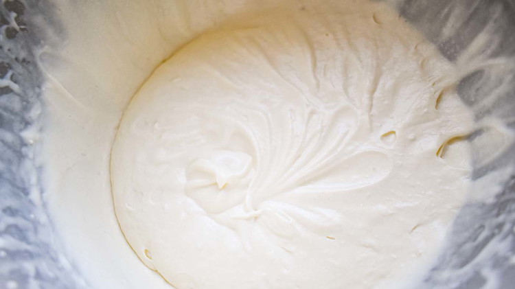 Image of In a separate bowl, mix half and half, egg yolks and vanilla. Pour the egg yolk mixture into the sugar mixture and mix.