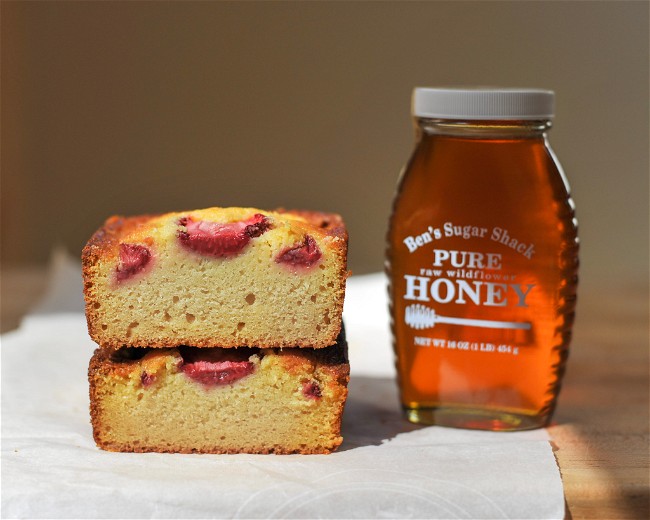 Image of Milk and Honey loaf cake with vanilla-honey sweetened strawberries and fresh cream