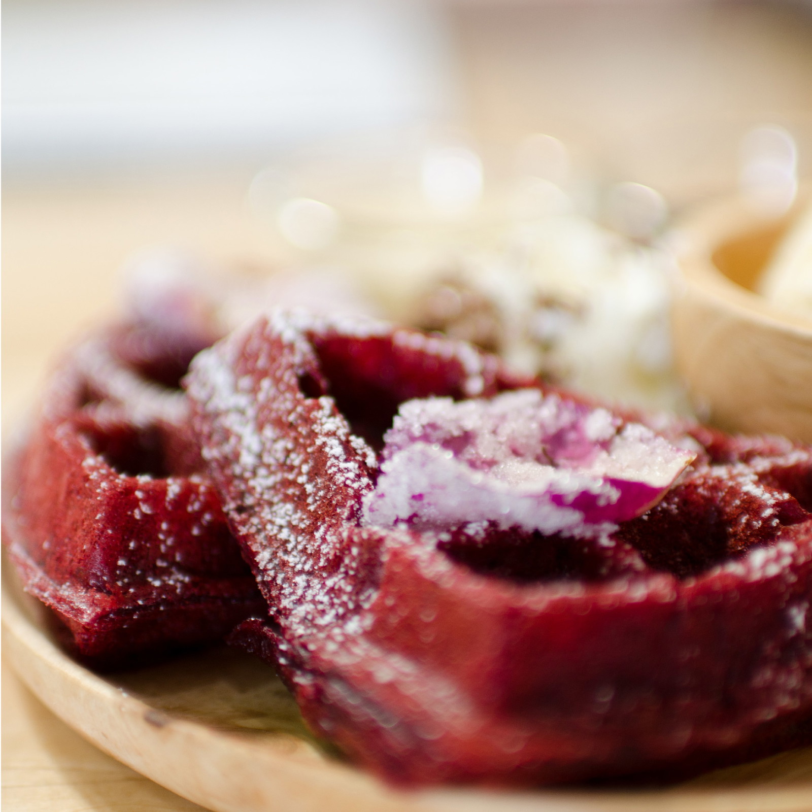 Red velvet waffles on a plate.