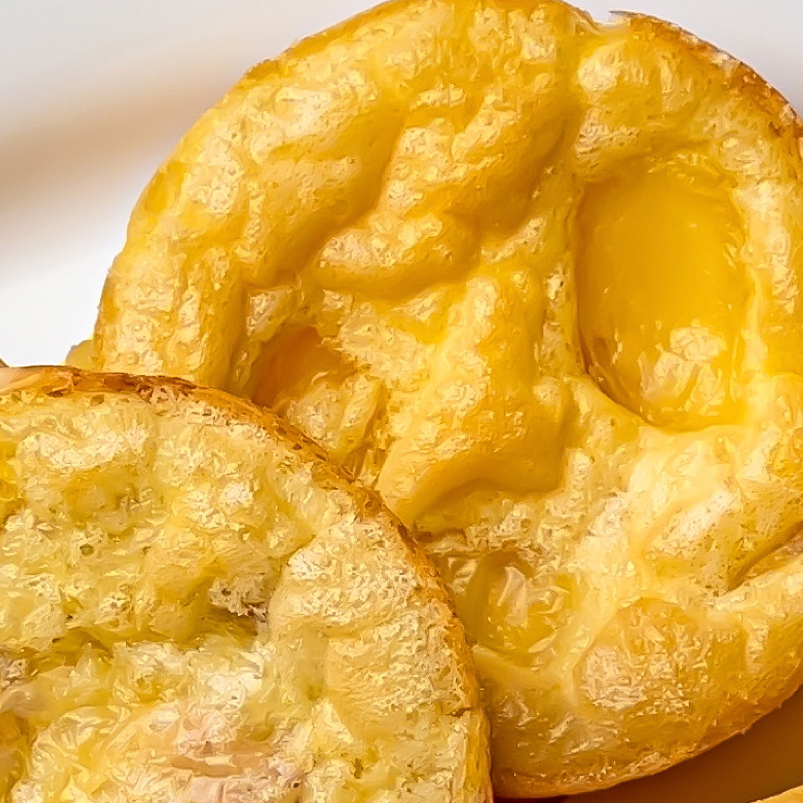 Two cheesy egg bites on a white plate.