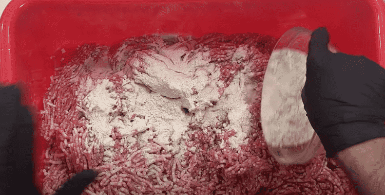 Image of Mix the meat together with your bologna seasoning pack, cure and water. Mix together until protein extraction starts and the meat becomes tacky.