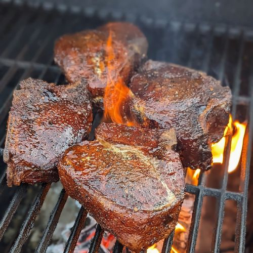 Image of Add more wood to the fire and set up the grill for high heat. Apply a thin coat of olive oil to all sides of the chops and sear directly over the flame for 30 seconds a side and a...