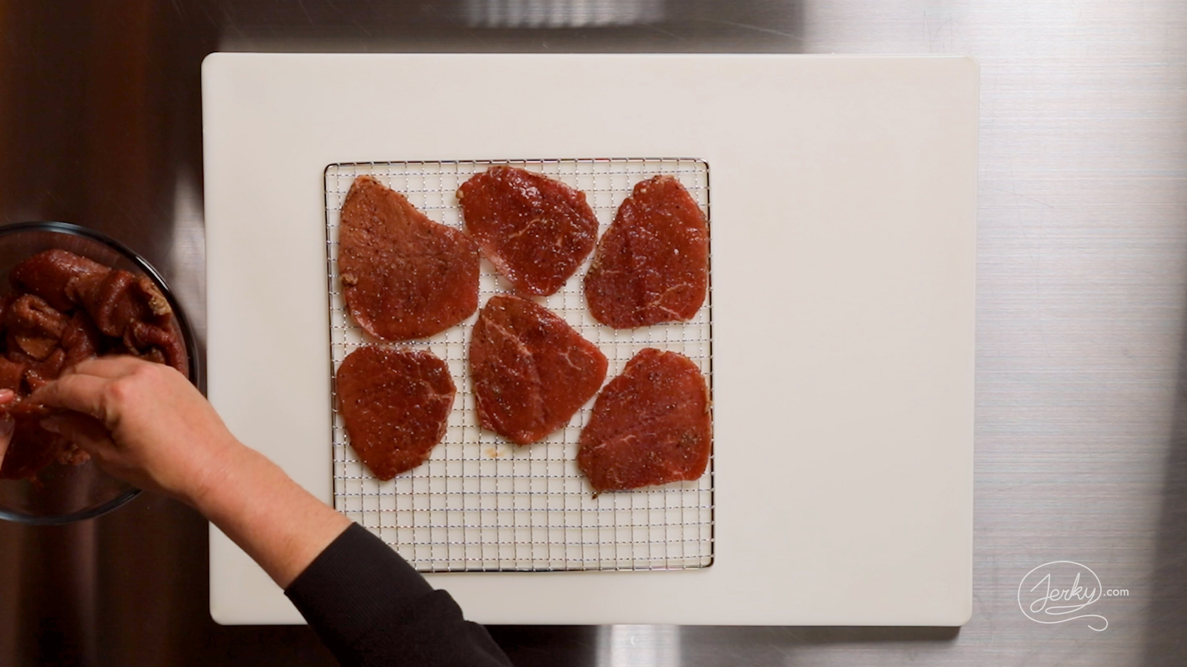 Image of After marinating, layout the meat on a dehydrator rack or...