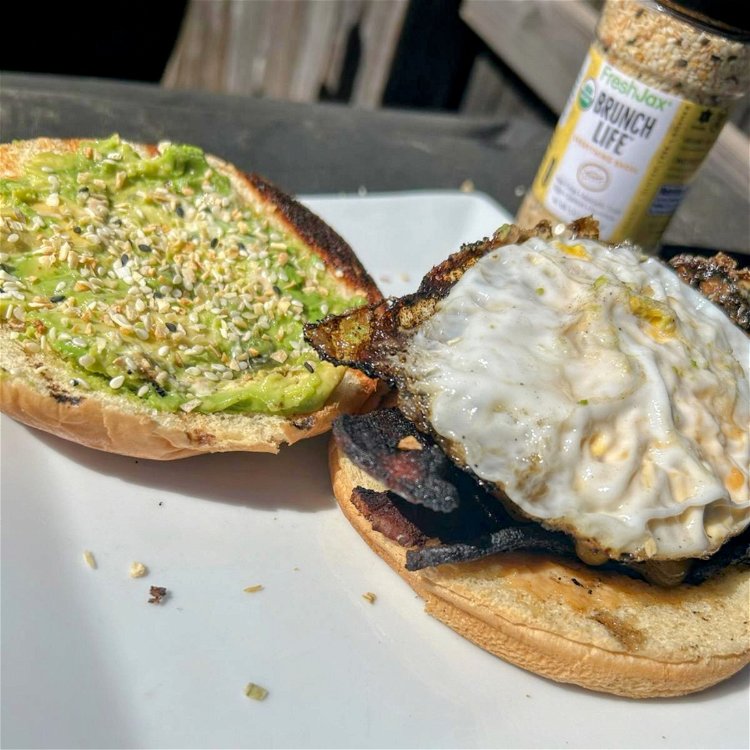 Image of Lightly toast the brioche buns and spread avocado on both...