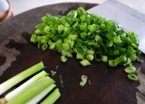 Image of Cut the scallions in pieces of about a half centimeter,...