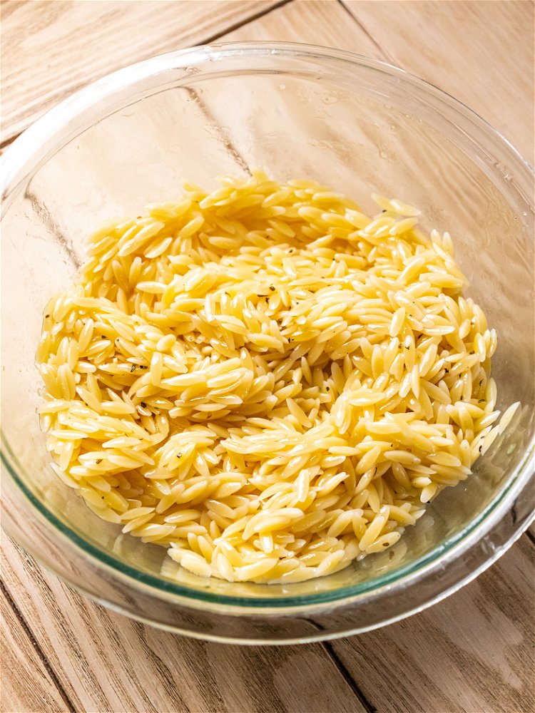 Image of Pour 1/4 cup of dressing over orzo and stir gently...
