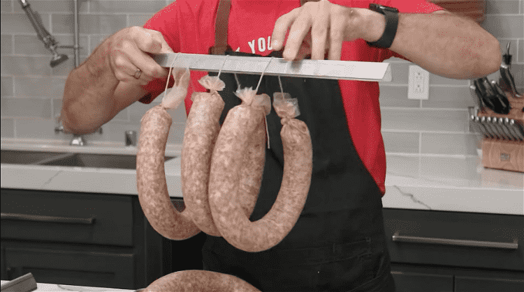 Image of Hang the ring bologna on smoke sticks, no more than 6 per stick to allow space between the sausages.