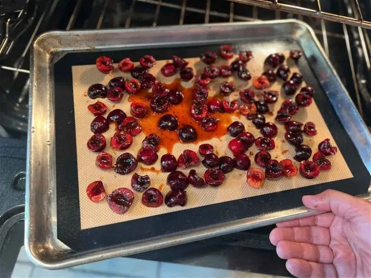 Image of Place cherries on a silicone baking mat and spread out...