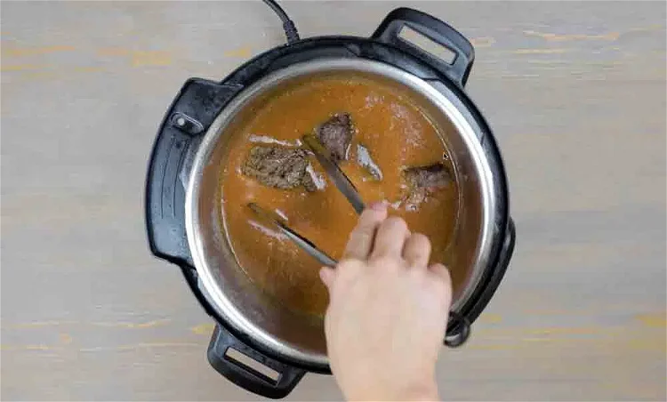 Image of Add the beef back into the pot. 