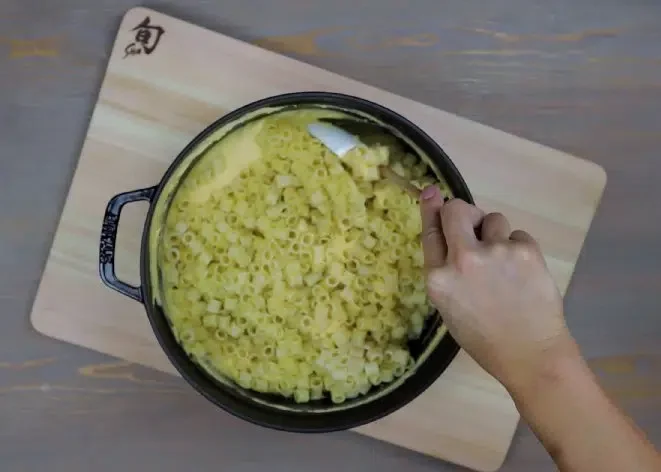 Image of In a large mixing bowl, combine drained pasta with cheese...