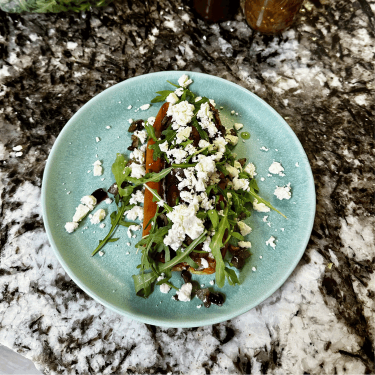 Image of Top with arugula, your sautéed combination, and feta cheese. Drizzle a little bit of the huckleberry BBQ sauce over the top and enjoy!