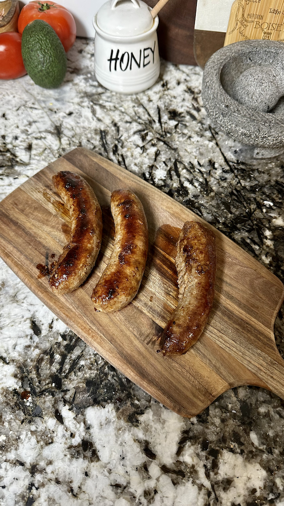 Image of Stir in your al dente pasta noodles and continue to cook. Remove your sausages from the pan and slice.
