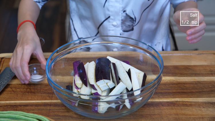 Image of Cut the eggplant into 3 inches long strips. Rub the eggplant with 1/2 tsp of salt and set it aside for 15 minutes. There are two purposes behind this step. The sodium will soften the flesh, making it easier to...