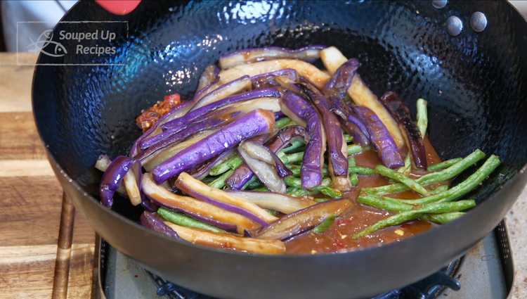 Image of Introduce the yard beans and the eggplant back into the wok. Pour in the sauce and stir over low heat for a couple of minutes or until the sauce thickens.