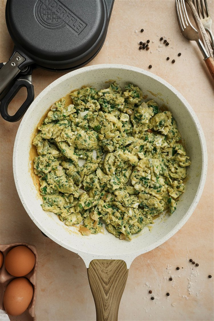 Image of Cook the eggs, adding some of the chermoula sauce in...