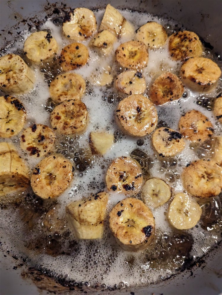 Image of Drain and dry plantain pieces. On medium-low heat, fry plantain...