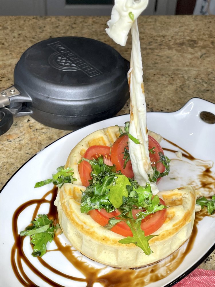 Image of Top the waffle with sliced tomato and the dressed arugula...