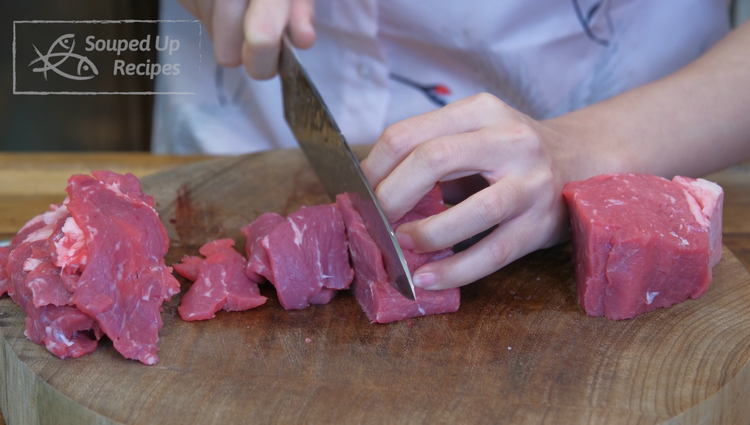 Image of Cut the beef into a few big chunks, then slice the beef into 1/8 of an inch thick slices. New York strip steak is pretty pricey. However, this recipe doesn't require expensive beef cuts. You can also use flank steak,...