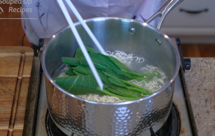 Image of Boil the noodles over medium heat for 1.5-3 minutes depending on your preference. while the noodle is cooking, add the green leavfy vegetables and cook for 20 seconds.